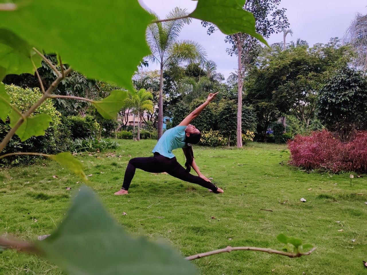 Triangle pose on green grass — breathwork